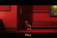 a person sitting on a red couch in a hallway with the words hey in white letters
