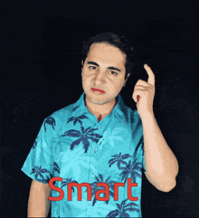 a man wearing a blue shirt with palm trees and the word smart