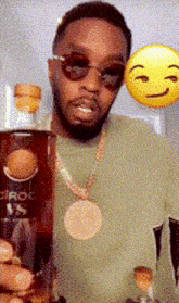 a man wearing sunglasses and a necklace holds a bottle of pepsi