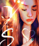 a woman is holding a heart in front of a microphone with the letter s in the corner