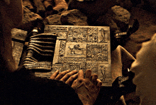 a person is looking at a book with a picture of a lion on it and the word egypt on it