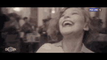 a black and white photo of a woman laughing in a restaurant .