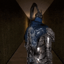 a statue of a knight with a blue cape and helmet is standing in a hallway