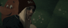 a woman wearing a beanie that says scl on it