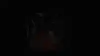 a yellow robot with the letter b on its face is in the dark