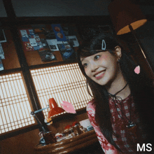 a woman in a plaid shirt is surrounded by pink petals and the letters ms on the bottom