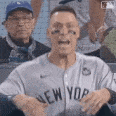 a man in a new york jersey is screaming in the stands
