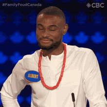 a man wearing a name tag that says albert on it