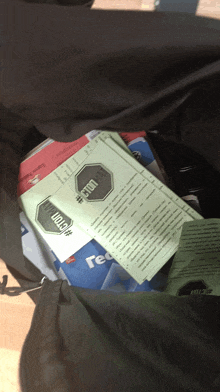 a bunch of papers in a bag one of which says #stop on it