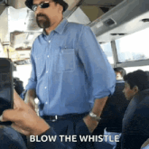 a man blowing a whistle on a bus while someone takes a picture