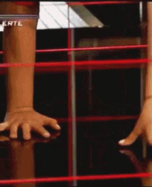 a close up of a person 's hands in a wrestling ring with the letters erte on the top