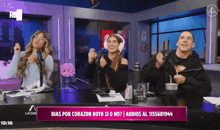 a group of people are sitting at a table with microphones and a sign that says dias por corazon roto si o no