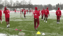 a group of soccer players are on a snowy field wearing adidas jerseys