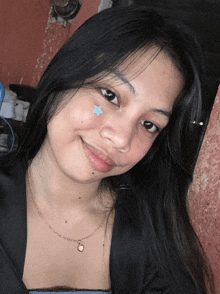 a young woman with a blue star on her face