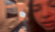 a blurry picture of a woman 's face with a light behind her