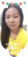 a woman in a yellow shirt is taking a selfie with the words selfie dulu sebelum solang below her