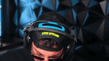 a man wearing headphones and a hat that says ever upward on it