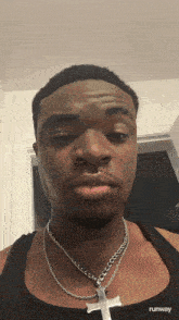 a man wearing a black tank top with runway on the bottom