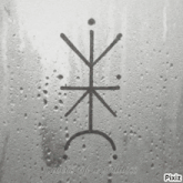a black and white photo of a symbol on a wet surface