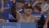 a man wearing a san diego padres baseball uniform holds a bat