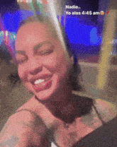 a woman with a tattoo on her chest is smiling and says nadie