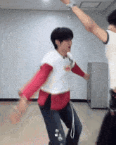two men are dancing in a room with one wearing a shirt that says ' i love you '