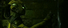 a person wearing a gas mask and goggles is standing in a dark room .