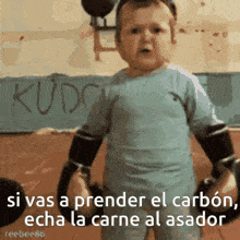 a baby with boxing gloves and the words si vas a prender el carbon eche la carne al asador