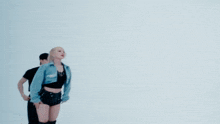 a group of people are dancing in front of a white backdrop