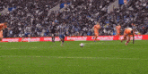 a soccer player is jumping in the air to catch a ball during a game .