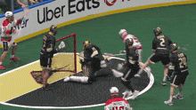 a lacrosse game is being played in front of a banner for uber eats