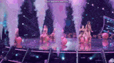 a group of women are dancing on a stage with smoke coming out of them and the words www.bandicam.com on the bottom