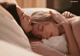 a couple of women laying on a bed with the word lingo on the bottom right