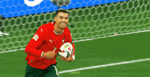a soccer player with the number 7 on his jersey is holding a ball