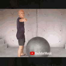 a youtube music ad with a man pointing at the camera