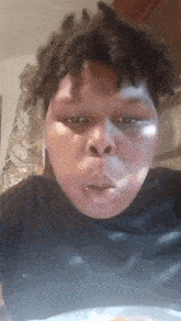 a man with dreadlocks is making a funny face