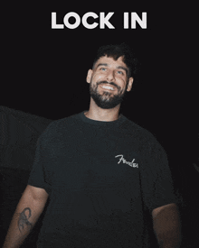 a man with a beard wearing a black fender t-shirt