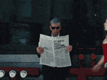 a man reading a newspaper that says city quietly agrees everything is slightly off