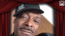 snoop dogg is wearing a hat that says gon't out