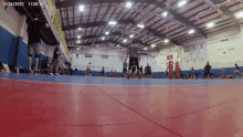 a group of people are playing basketball in a gym with the date of 12/24/22