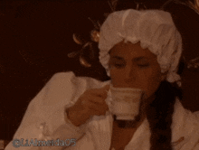 a woman wearing a white robe and a white hat has the number 05 on the bottom right