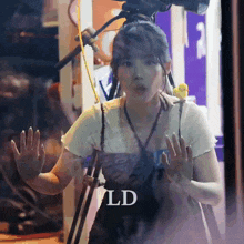 a woman is standing in front of a camera with ld written on the bottom
