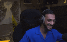 a man wearing headphones is sitting in a chair with his arms outstretched