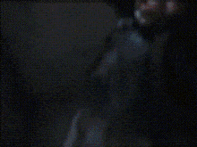 a silhouette of a person holding a gun in front of a window .