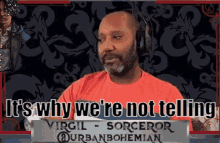 a man wearing headphones and a red shirt says it 's why we 're not telling .