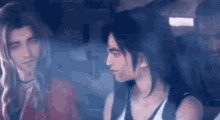 a man and a woman are sitting next to each other in a car and looking at each other .
