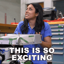 a woman in a blue shirt with the words this is so exciting