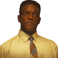 a man wearing a yellow shirt and tie looks to the side