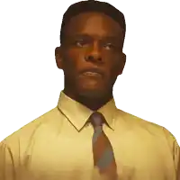 a man wearing a yellow shirt and tie looks to the side