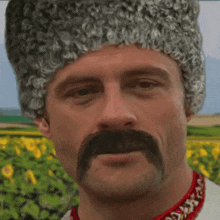 a man with a mustache and a fur hat